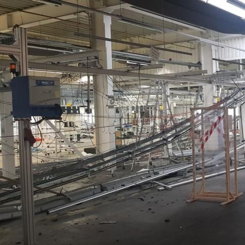 Räumlichkeit mit unordentlichen Rohren und Apparaten, Baustellenumgebung sichtbar.